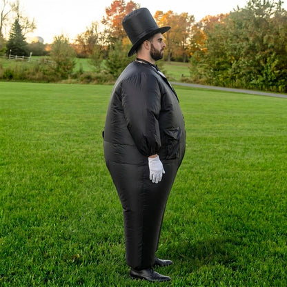Side profile of inflatable tuxedo groom costume showing the round black suit and white glove