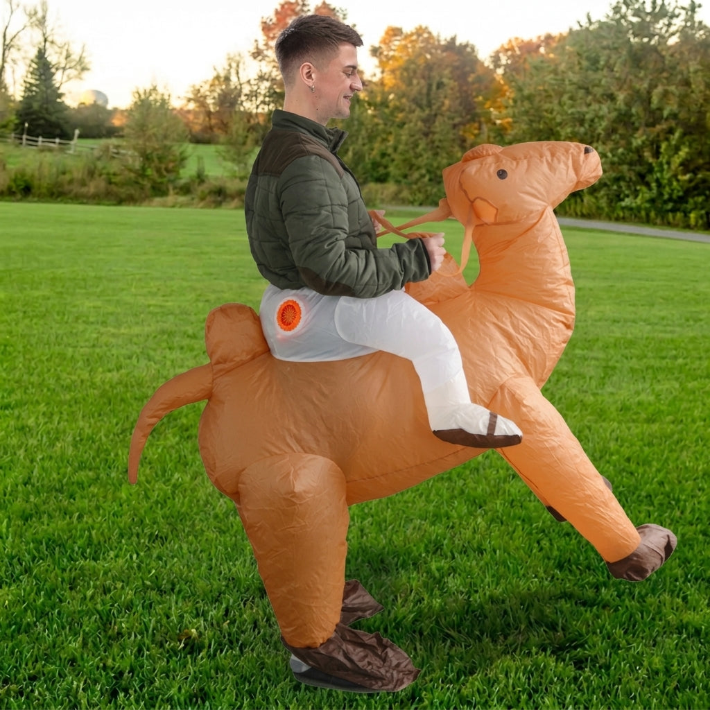 Side profile of inflatable ride on camel costume showing the hump, tail and reins in a grass field