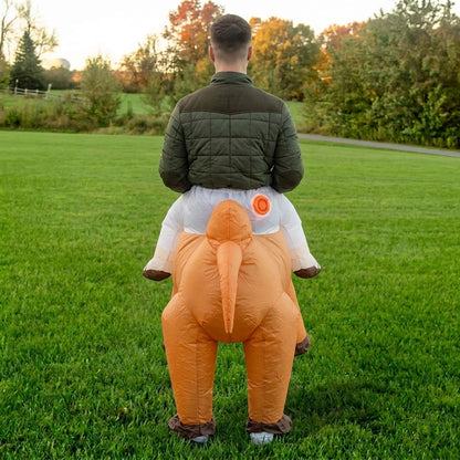 Back view of ride on camel costume showing the camel tail and faux rider legs in white pants