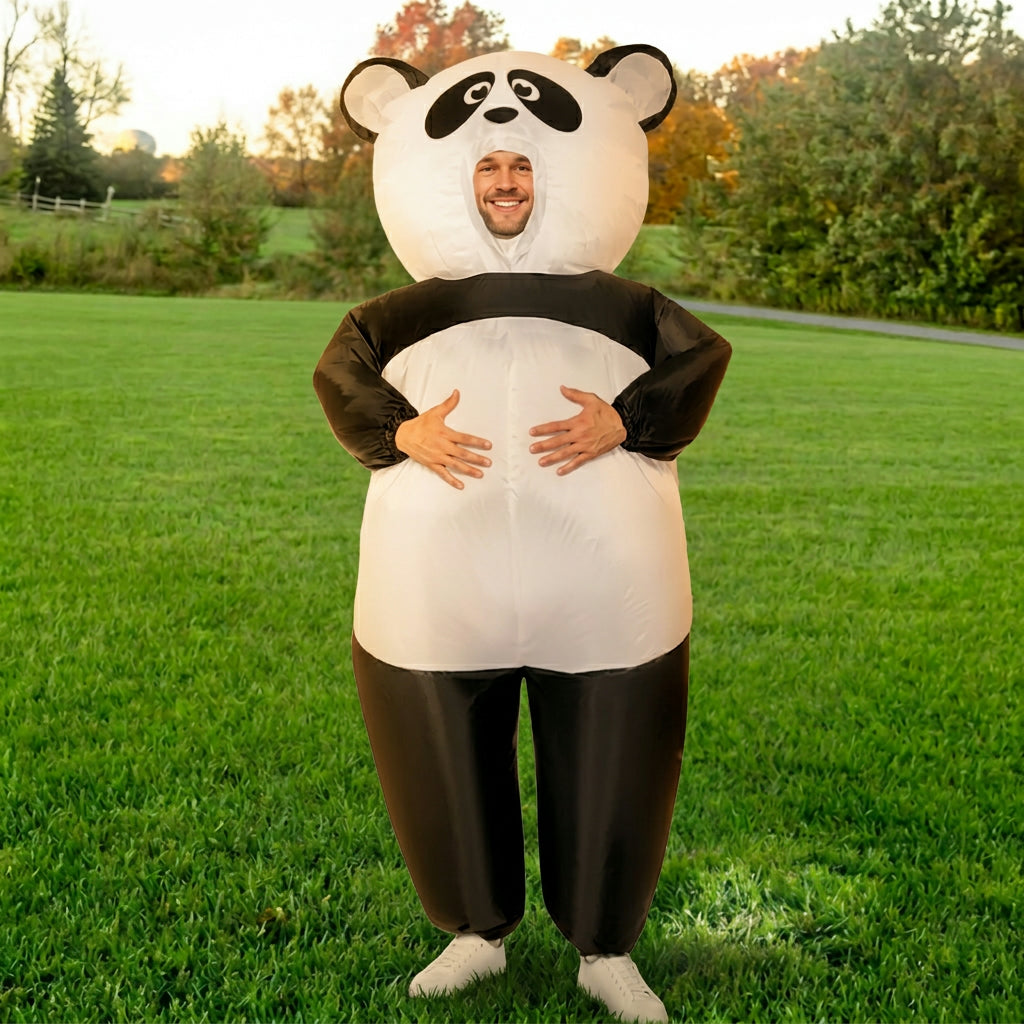 Front view of adult in panda suit with hands on the round belly, black legs and white body