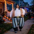 Adult in inflatable pirate costume on a Halloween porch path, white shirt, brown vest and striped pants